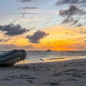 Dingy sitting on beach on Caribbean sailing tours