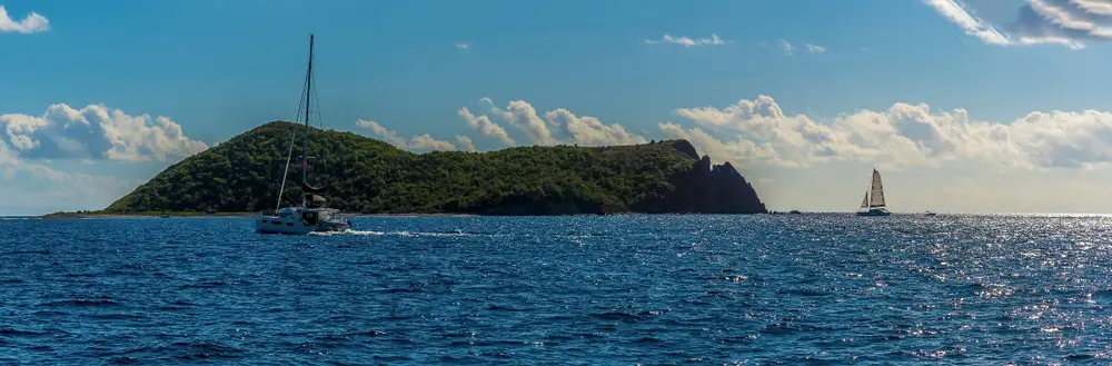 Boats sailing off the coast of Dead Chest Island, British Virgin Isles